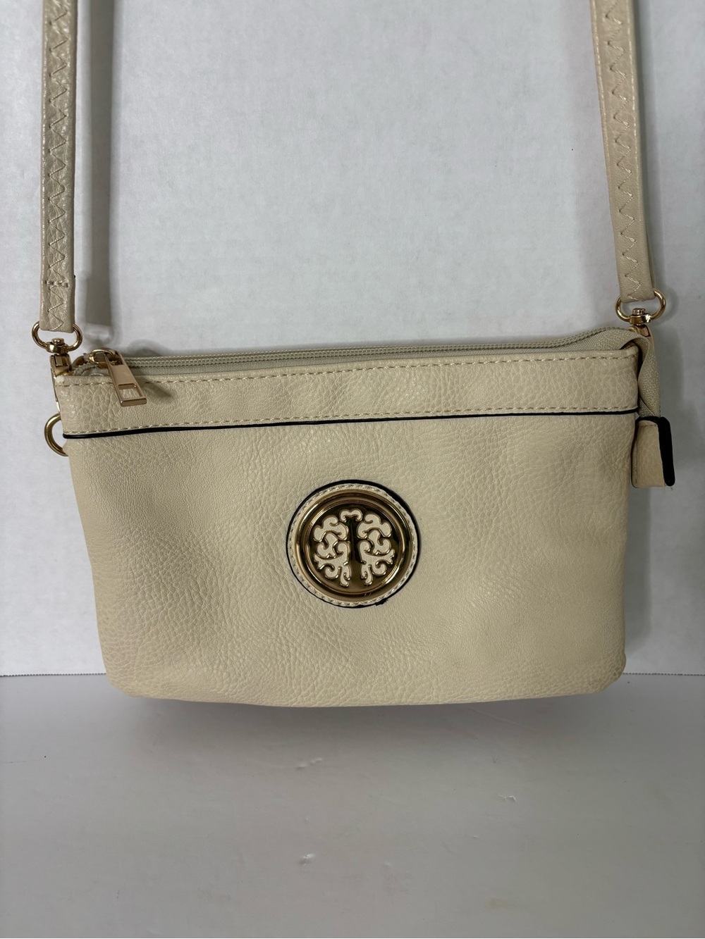 Euro Trends Cream Crossbody with Gold Medallion Accent